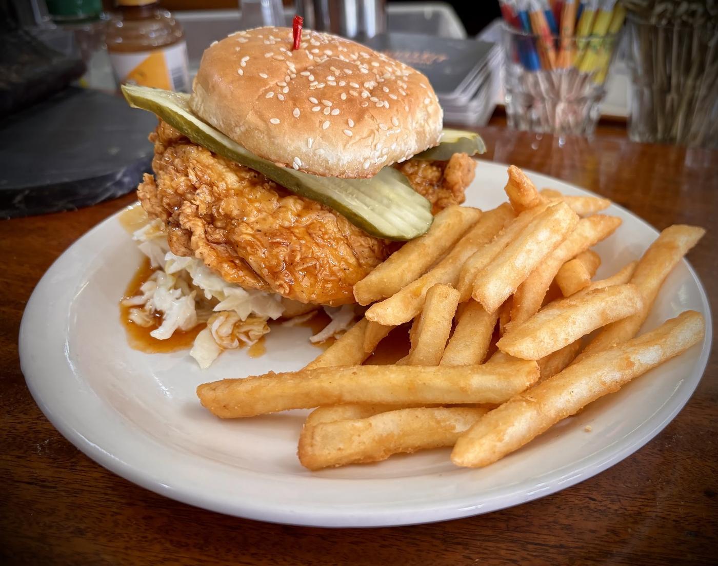 Fried chicken sandwich with pickles and fries