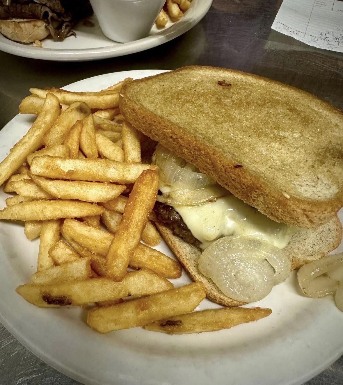 Patty melt on toasted bread with fries
