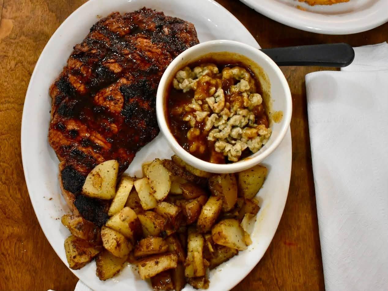 Grilled steak with German fries and spaetzle in gravy